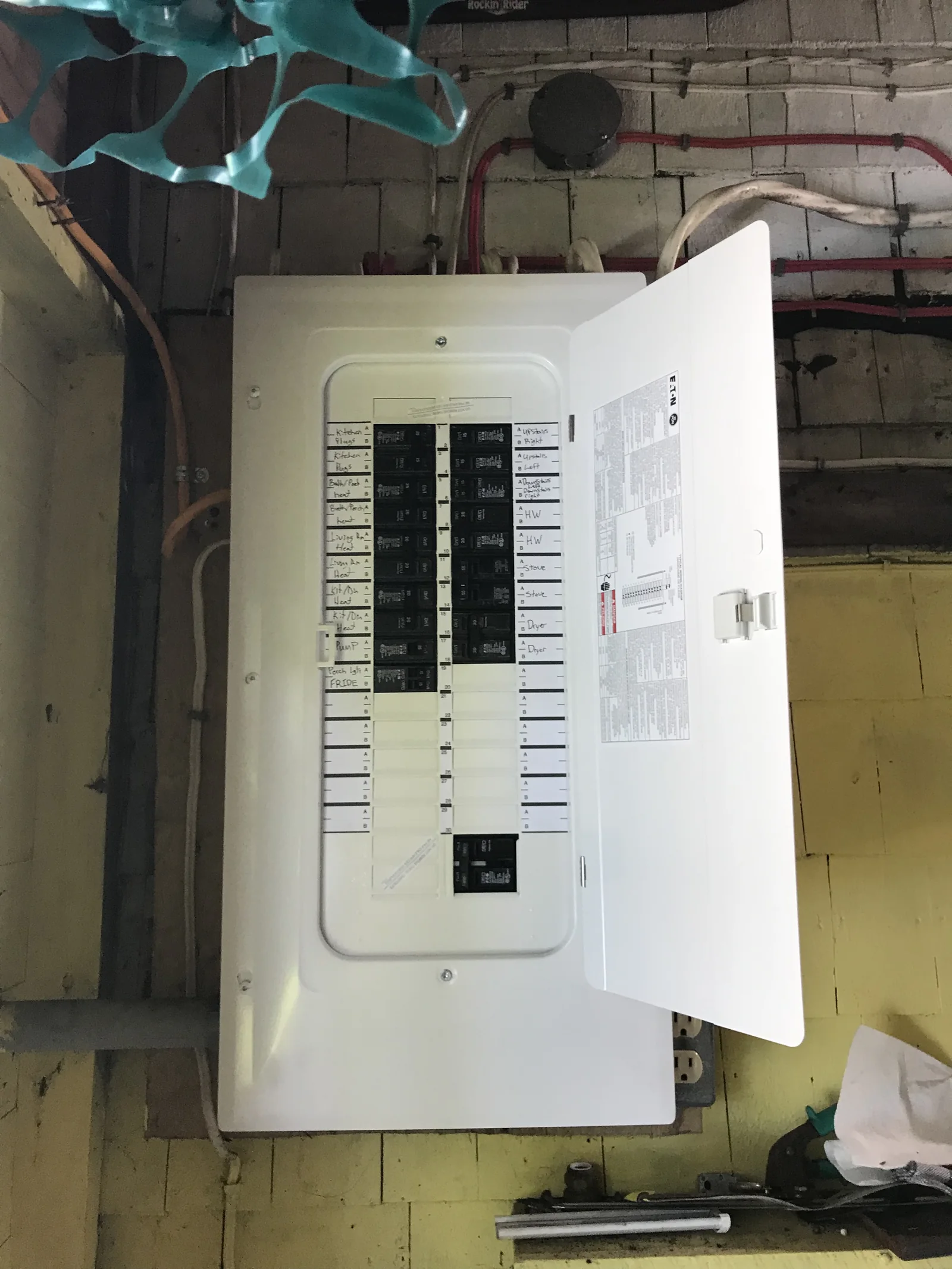 Installed residential electrical panel with its door open and circuits labelled