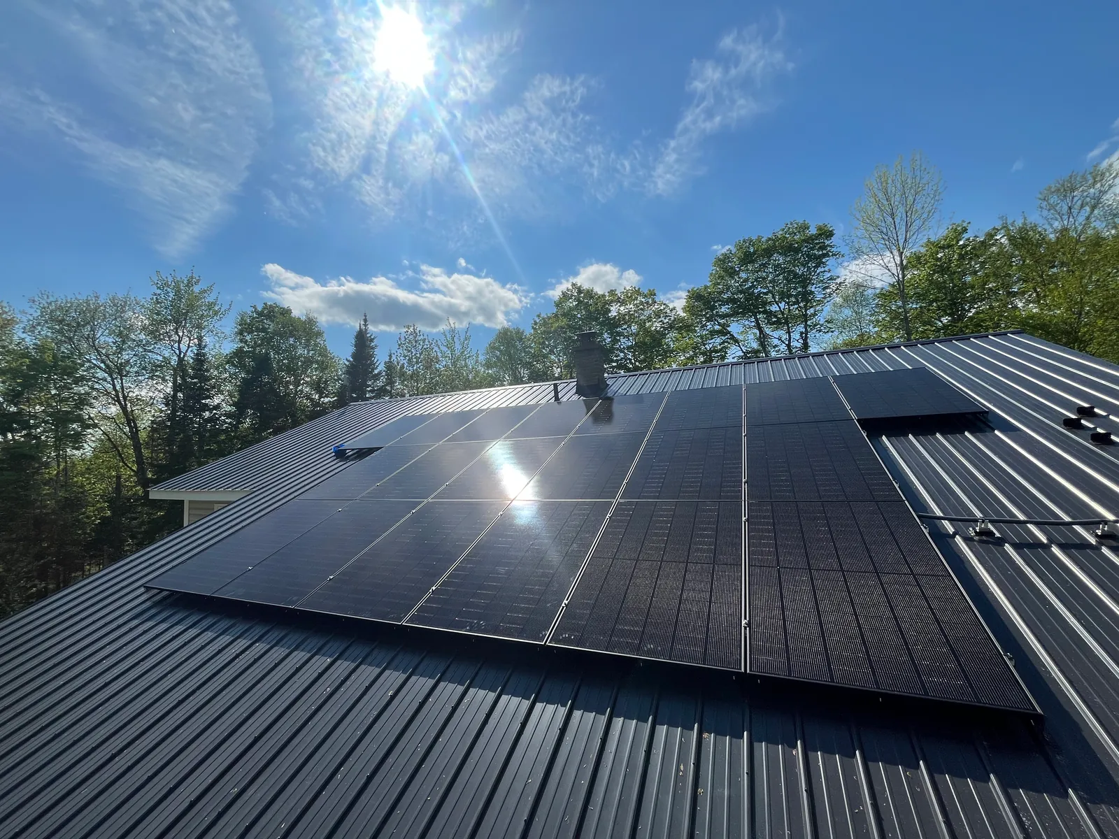 Solar panels installed by JTA Electric on a dark metal roof