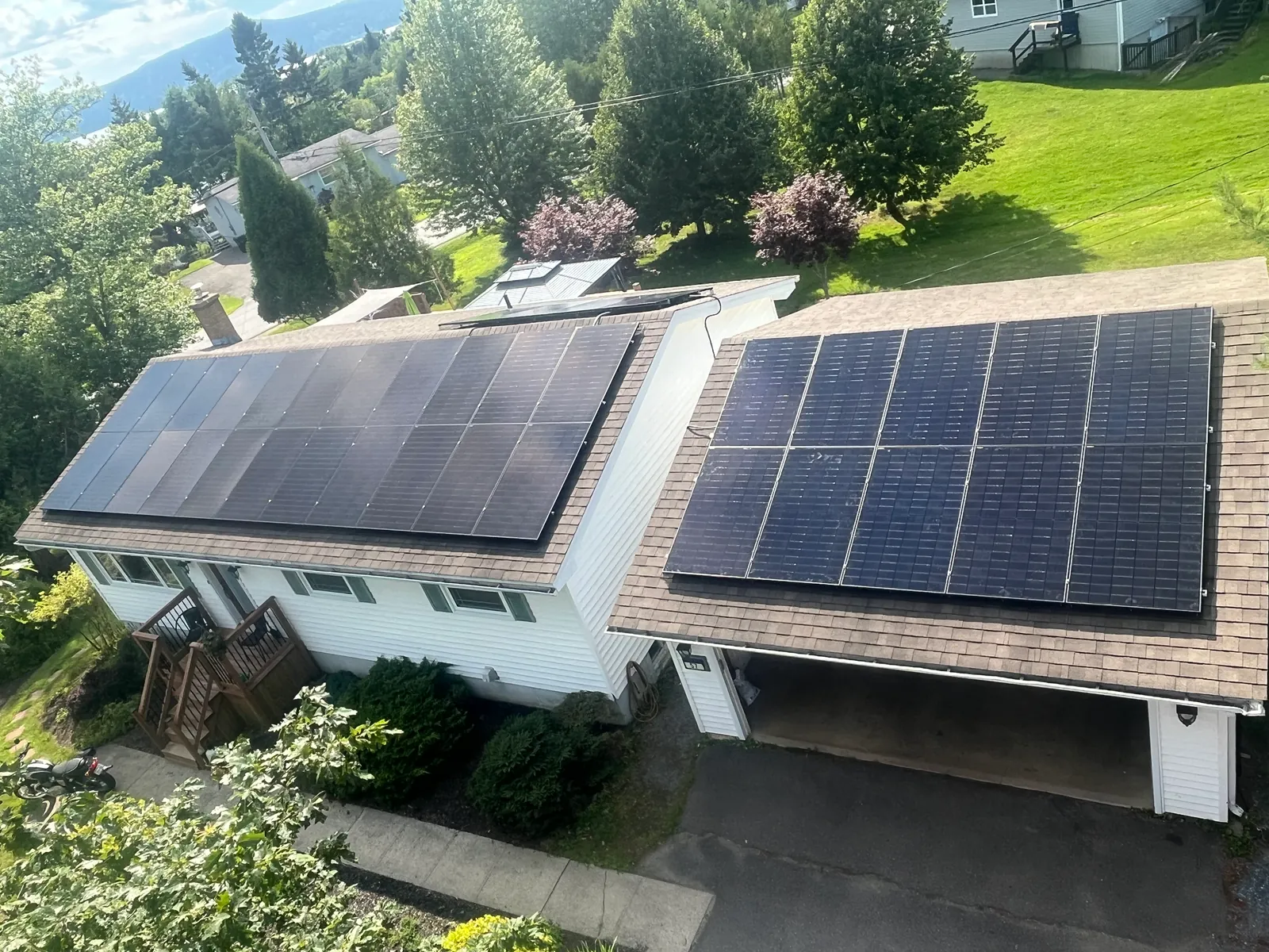 Rooftop solar arrays installed by JTA Electric on a home and garage
